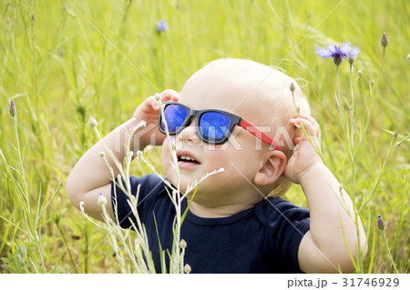 Funny baby boy in sunglasseslooking at sun in the Funny baby boy in sunglasseslooking at sun in the 31746929