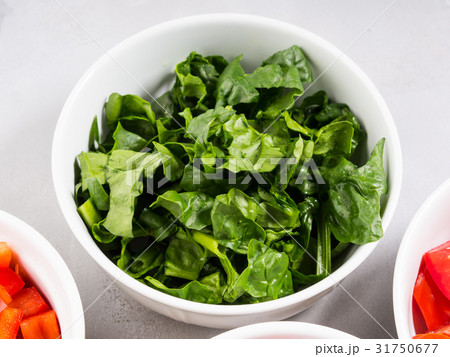 Spinach leaves in bowl. Closeup Spinach leaves in bowl. Closeup 31750677