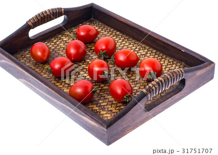 Brown wooden tray with small red tomatoes Brown wooden tray with small red tomatoes 31751707