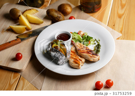 Grilled chicken fillets, chili pepper and tomatoes Grilled chicken fillets, chili pepper and tomatoes 31753259