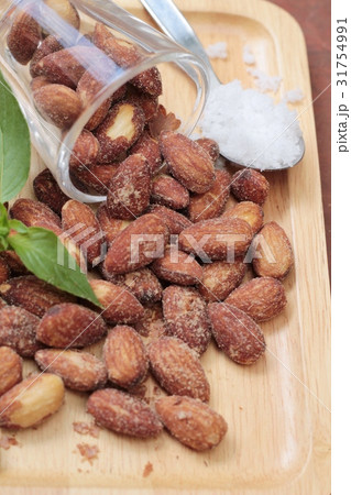 Almonds nuts with salt on wood background. 31754991