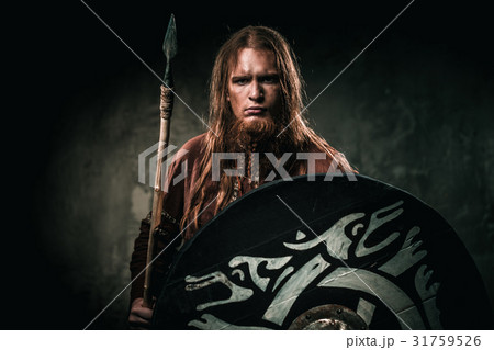Serious viking with a spear in a traditional Serious viking with a spear in a traditional 31759526