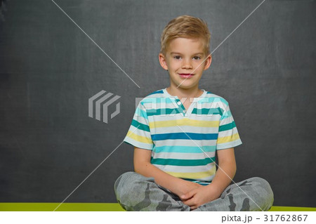 Boy posing with blackboard behind him Boy posing with blackboard behind him 31762867