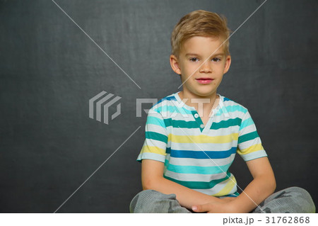 Boy posing with blackboard behind him Boy posing with blackboard behind him 31762868
