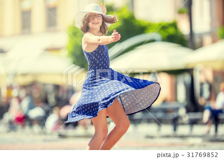 Cute happy girl in summer outfit dancing. 31769852