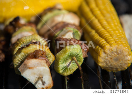 close on raw meat with fruits on the grill close on raw meat with fruits on the grill 31771842