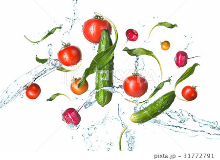 The fresh tomatos, cucumbers, radish in spray of 31772791