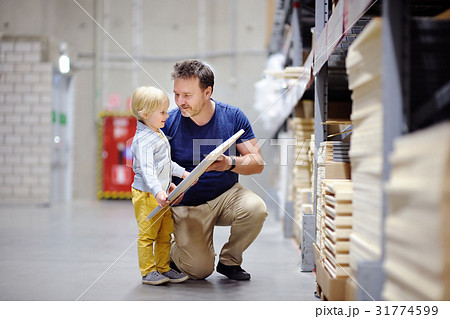 father with boy choosing the right furniture 31774599