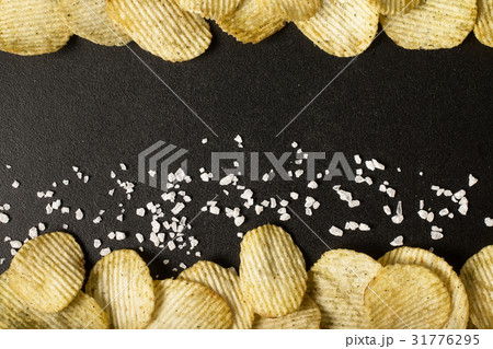 Crinkle cut potato chips on a blackboard 31776295