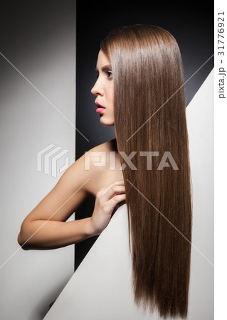 Portrait of long-haired brunette looking away Portrait of long-haired brunette looking away 31776921