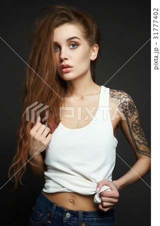 Young blond woman with tattoo Young blond woman with tattoo 31777402