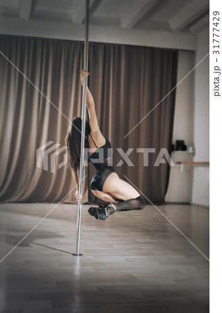 Girl pole dancer on training. Girl pole dancer on training. 31777429