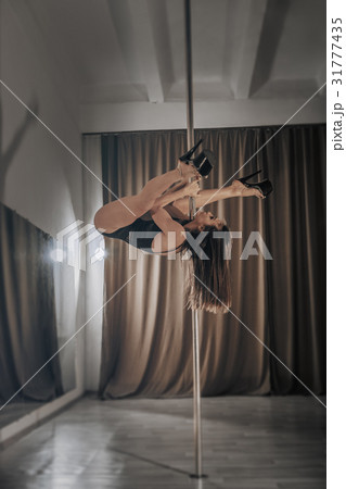 Girl pole dancer on training. Girl pole dancer on training. 31777435