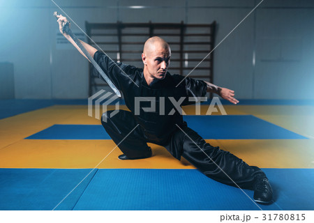 Wushu master training with sword, martial arts Wushu master training with sword, martial arts 31780815