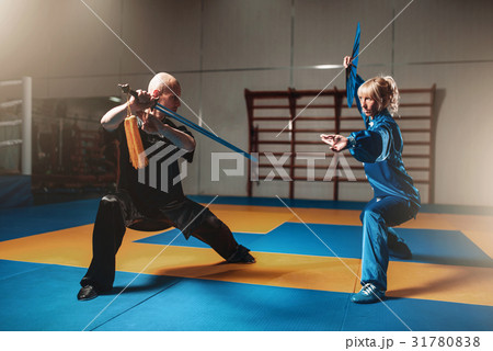 Wushu fighters, man and woman with swords Wushu fighters, man and woman with swords 31780838