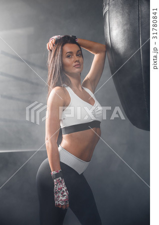 Portrait of young fitness woman flexing muscles Portrait of young fitness woman flexing muscles 31780841