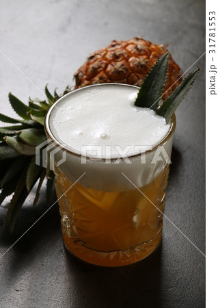 Pineapple and a glass of beer 31781553