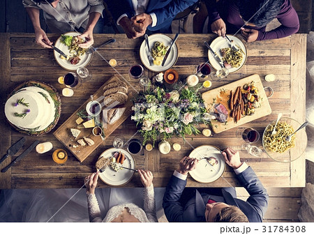 Bride and Groom Having Meal with Friends at Wedding Reception 31784308