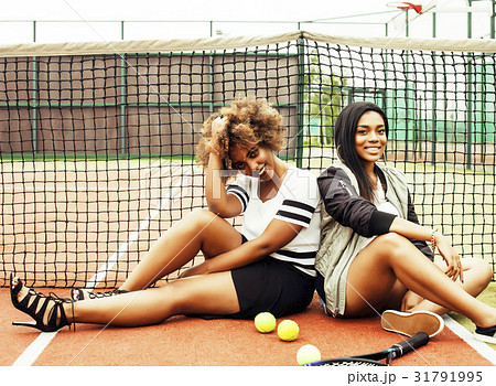young pretty girlfriends hanging on tennis court 31791995