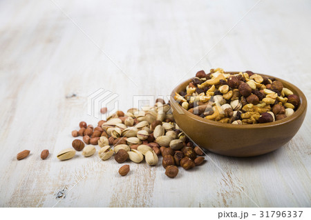 Nuts in a wooden bowl on a wooden table Nuts in a wooden bowl on a wooden table 31796337
