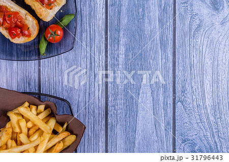 Italian bruschetta and a plate of french fries Italian bruschetta and a plate of french fries 31796443