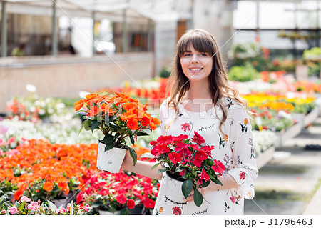 Young woman buying flowers at a garden center 31796463