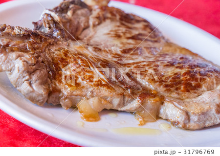 Closeup of a grilled steak on white plate Closeup of a grilled steak on white plate 31796769