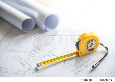 architectural drawing and tape measure on table architectural drawing and tape measure on table 31802673