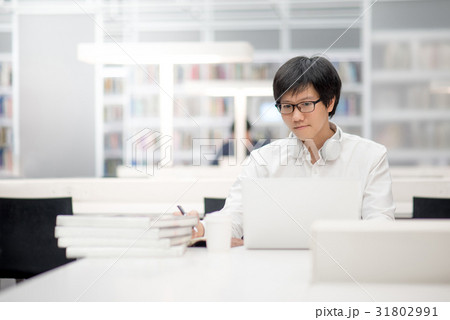 Young Asian university student working in library Young Asian university student working in library 31802991