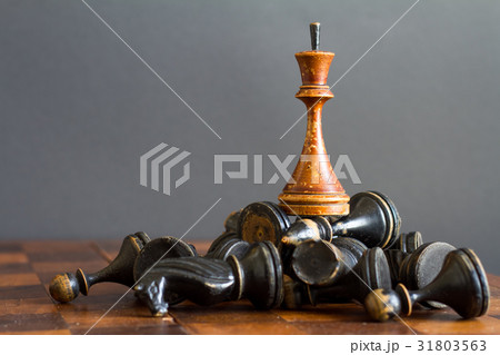 Vintage wooden chess pieces on an old chessboard. Vintage wooden chess pieces on an old chessboard. 31803563