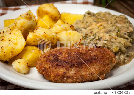 Delicious meal of minced meat cutlet and potatoes. Delicious meal of minced meat cutlet and potatoes. 31804887