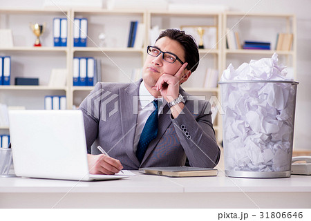 Businessman in paper recycling concept in office Businessman in paper recycling concept in office 31806646