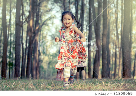 Cute asian little girl running in the park 31809069