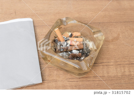 cigarette with an ashtray on the wood table 31815702