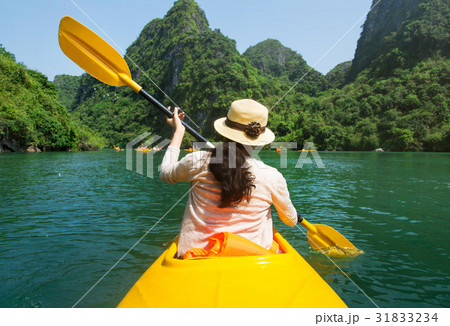 Girl kayaking on seaside of Halong bay in Vietnam Girl kayaking on seaside of Halong bay in Vietnam 31833234