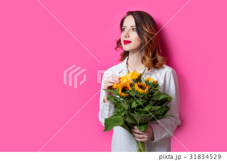 Portrait of young red-haired girl with sunflowers 31834529