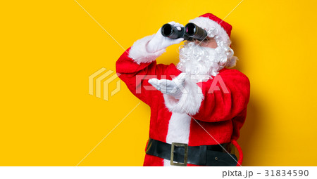 Funny Santa Claus holding binoculars 31834590