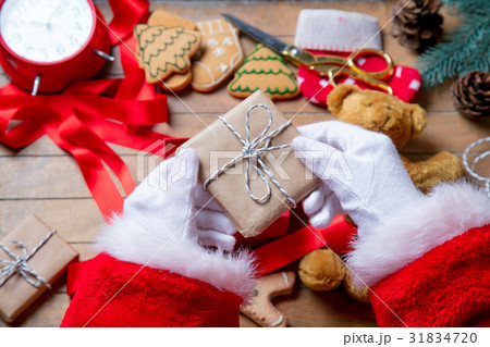 Santa Claus have wrapping a Christmas present box 31834720