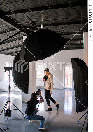 Photographer and model during studio session 31835614