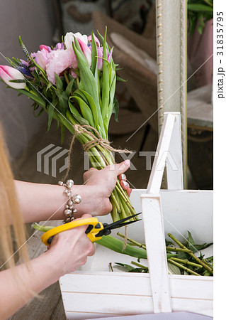 Woman making tulip bouquet top view 31835795