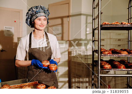 baker standing in his bakery in the morning and is 31839055