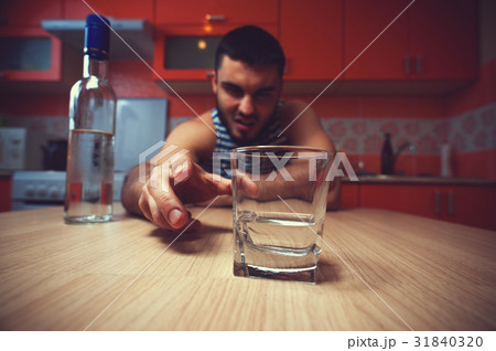 Young drunk man sitting on the table 31840320
