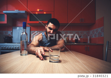 Young caucasian man drinking alcohol at home Young caucasian man drinking alcohol at home 31840321
