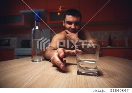 Young caucasian man drinking alcohol at home Young caucasian man drinking alcohol at home 31840347