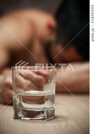 Alcoholic man sleeping at the table Alcoholic man sleeping at the table 31840395