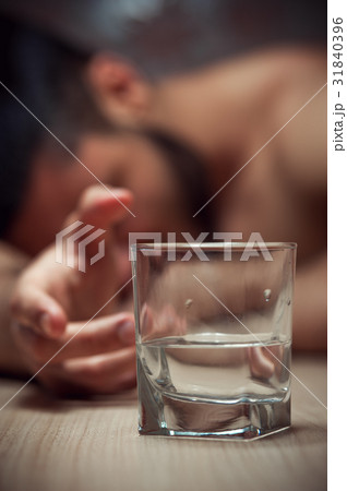 Drunken man sleeping with glass of alcohol Drunken man sleeping with glass of alcohol 31840396
