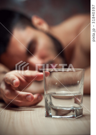 Alcoholic man sleeping at the table Alcoholic man sleeping at the table 31840397