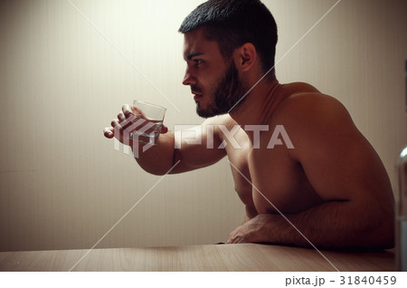 Young caucasian man drinking alcohol at home Young caucasian man drinking alcohol at home 31840459