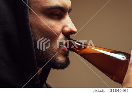 Sad depressed young man drinking beer Sad depressed young man drinking beer 31840465