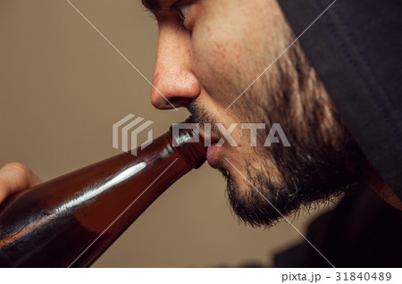 Closeup of Young drunk man with beer bottle 31840489